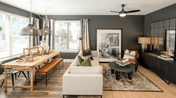 A modern living room with a dining table and a white sofa.